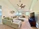 Spacious living room featuring a sectional sofa, large TV, and vaulted ceiling at 5271 Whitstable Way # 1, Orlando, FL 32812