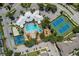 Aerial view showing resort-style amenities including pool, tennis courts, and playground at 8059 King Palm Cir, Kissimmee, FL 34747