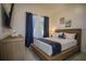 Spacious bedroom with a king-size bed, large windows and dark blue curtains at 8059 King Palm Cir, Kissimmee, FL 34747