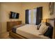 Bright bedroom with a large bed, dresser, and TV at 8059 King Palm Cir, Kissimmee, FL 34747