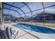 Screened-in pool and patio area with lounge chairs at 8059 King Palm Cir, Kissimmee, FL 34747