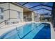 Inviting kidney-shaped pool with screened enclosure at 8059 King Palm Cir, Kissimmee, FL 34747