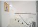 Upper hallway with glass railing and modern art at 8059 King Palm Cir, Kissimmee, FL 34747