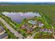 Aerial view of community with lake, pool, and clubhouse at 8127 Cadman St, Orlando, FL 32832