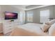 Main bedroom with a dresser, large bed, and mounted TV at 8127 Cadman St, Orlando, FL 32832