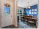 Bright dining room with blue accent wall, wooden table, and six chairs at 8127 Cadman St, Orlando, FL 32832