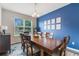 Bright dining room with blue accent wall, wooden table, and six chairs at 8127 Cadman St, Orlando, FL 32832
