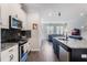 Modern kitchen with white cabinets, granite island, and stainless steel appliances at 8127 Cadman St, Orlando, FL 32832