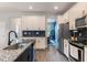 Modern kitchen with white cabinets, granite island, and stainless steel appliances at 8127 Cadman St, Orlando, FL 32832