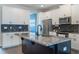 Modern kitchen with white cabinets, granite island, and stainless steel appliances at 8127 Cadman St, Orlando, FL 32832