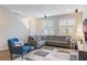 Bright and airy living room with a comfortable sectional sofa and large windows at 8127 Cadman St, Orlando, FL 32832