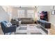Spacious living room featuring a large sectional sofa, and a mounted TV at 8127 Cadman St, Orlando, FL 32832