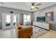 Living room with large windows, brown couch, and a modern media console at 10832 Arbor View Blvd, Orlando, FL 32825