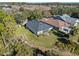 House and backyard with screened porch and landscaping at 1592 Lincolnshire Drive, Deland, FL 32724