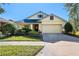 Beautiful one-story home with a two-car garage and well-manicured lawn at 1592 Lincolnshire Drive, Deland, FL 32724