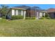Single-story house with screened porch and manicured lawn at 1592 Lincolnshire Drive, Deland, FL 32724
