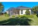 House exterior showcasing a screened porch and yard at 1592 Lincolnshire Drive, Deland, FL 32724