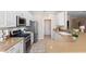 Open kitchen featuring stainless steel appliances and an island at 1592 Lincolnshire Drive, Deland, FL 32724