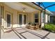 Covered patio with wicker furniture and French doors at 1592 Lincolnshire Drive, Deland, FL 32724