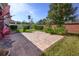 Private backyard patio with brick pavers, lush landscaping, and brick wall at 1722 Farmstead Ln, Oviedo, FL 32765