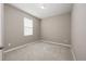 Simple bedroom with neutral walls and carpet flooring at 1722 Farmstead Ln, Oviedo, FL 32765