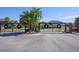 Gated community entrance with palm trees and holiday decorations at 1722 Farmstead Ln, Oviedo, FL 32765