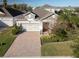 Two-story home with a paver driveway and landscaped yard at 1722 Farmstead Ln, Oviedo, FL 32765