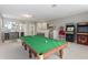 Game room with a pool table and arcade games at 1722 Farmstead Ln, Oviedo, FL 32765