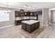 Island kitchen with stainless steel appliances and breakfast bar at 1722 Farmstead Ln, Oviedo, FL 32765