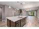 Open kitchen with island, dark cabinetry, and stainless steel appliances at 1722 Farmstead Ln, Oviedo, FL 32765