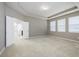 Spacious main bedroom with carpet and tray ceilings at 1722 Farmstead Ln, Oviedo, FL 32765