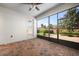 Bright screened patio with brick flooring, access door, and view of backyard at 1722 Farmstead Ln, Oviedo, FL 32765