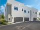 Modern townhouses with attached garages and a paved driveway at 1778 Mondrian Cir, Winter Park, FL 32789