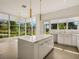 Modern kitchen island with white cabinets and countertops at 1778 Mondrian Cir, Winter Park, FL 32789