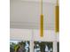 Close-up of sleek gold pendant lights above kitchen window at 1778 Mondrian Cir, Winter Park, FL 32789