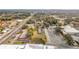 Aerial view of a commercial property next to a highway, with a view of nearby residences and town at 201 N East St, Leesburg, FL 34748