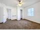 Cozy bedroom featuring soft carpet, natural light, and access to an ensuite bathroom and closet space at 201 N East St, Leesburg, FL 34748