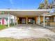 Spacious carport featuring two garage door entrances, suitable for parking and storage at 201 N East St, Leesburg, FL 34748