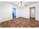 Dining room boasts wood-look floors, white walls, chandelier, and open archway to the kitchen at 201 N East St, Leesburg, FL 34748