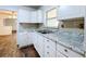 Bright kitchen features white cabinets, modern countertops, and stainless steel faucet at 201 N East St, Leesburg, FL 34748