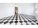 Bright living room features a unique black-and-white checkered floor and a bright window at 201 N East St, Leesburg, FL 34748