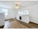 Open living room featuring white brick walls, a unique fireplace, and natural light from multiple windows at 201 N East St, Leesburg, FL 34748