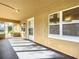 Inviting front porch with natural lighting, perfect for relaxation and enjoying the outdoors at 201 N East St, Leesburg, FL 34748