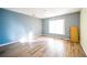 Bright bedroom with wood-look floors and a large window at 266 Vervain Ave, Davenport, FL 33837