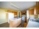 Kitchen with light wood cabinets, white appliances, and an island at 266 Vervain Ave, Davenport, FL 33837