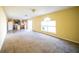 Spacious living room with carpet and view into kitchen at 266 Vervain Ave, Davenport, FL 33837
