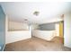 Open loft area with carpet flooring and access to other rooms at 266 Vervain Ave, Davenport, FL 33837