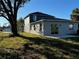 Two-story house back view, with sliding glass doors leading to a patio at 2903 Travelers Palm Dr, Edgewater, FL 32141