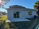 View of house back, showcasing a patio and sliding glass doors at 2903 Travelers Palm Dr, Edgewater, FL 32141