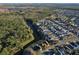 Aerial view showing home's location in a quiet residential neighborhood near a lake at 2981 Viscount Cir, Kissimmee, FL 34747